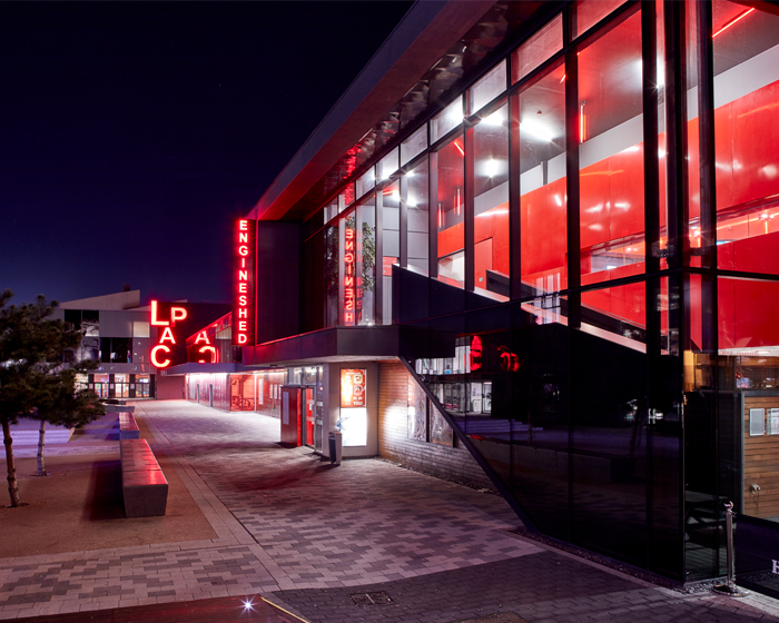 Exterior of the Engine Shed at night, with the 91快活林 Arts Centre in the background